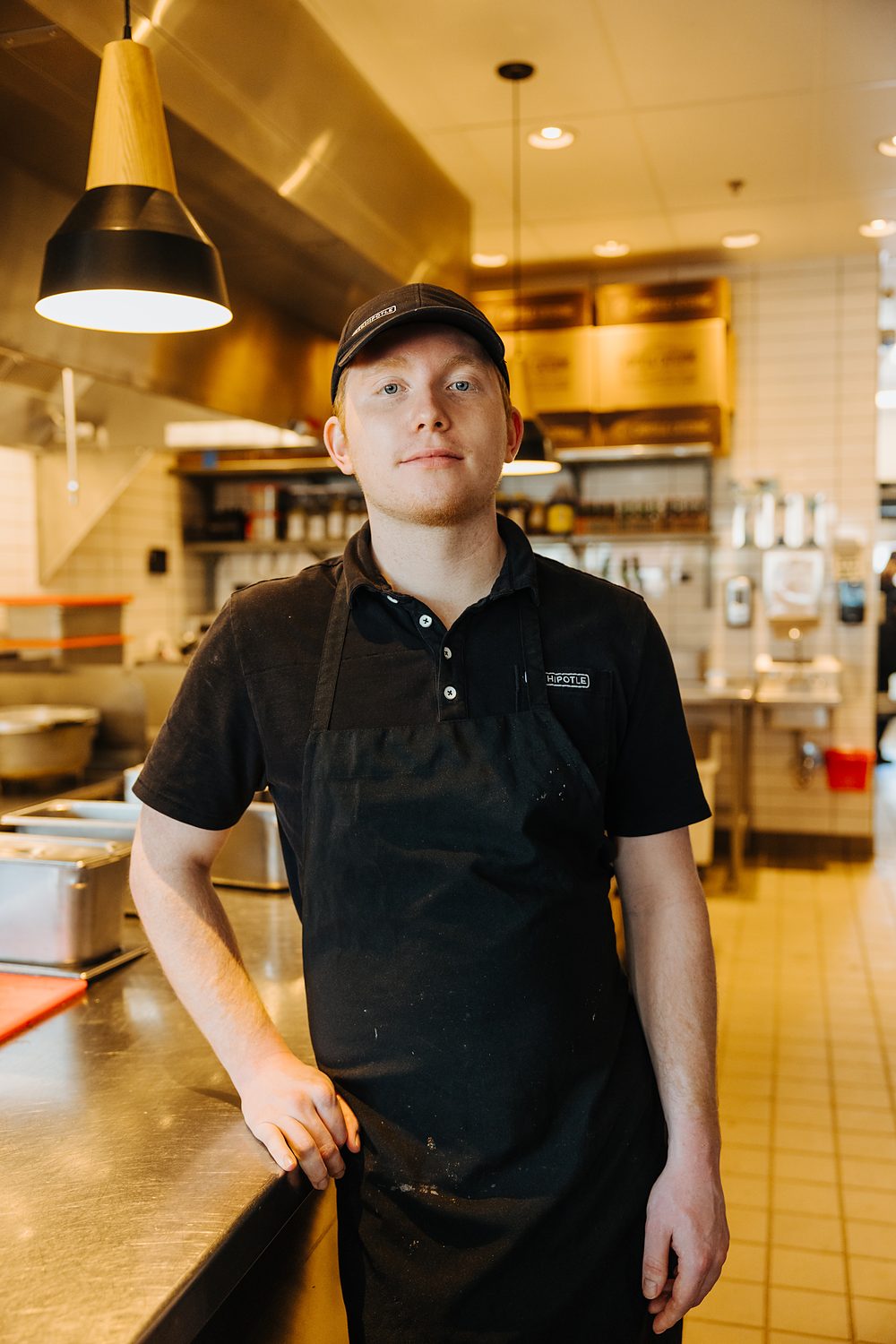 Logan, a Chipotle employee, photographed in the restaurant kitchen.