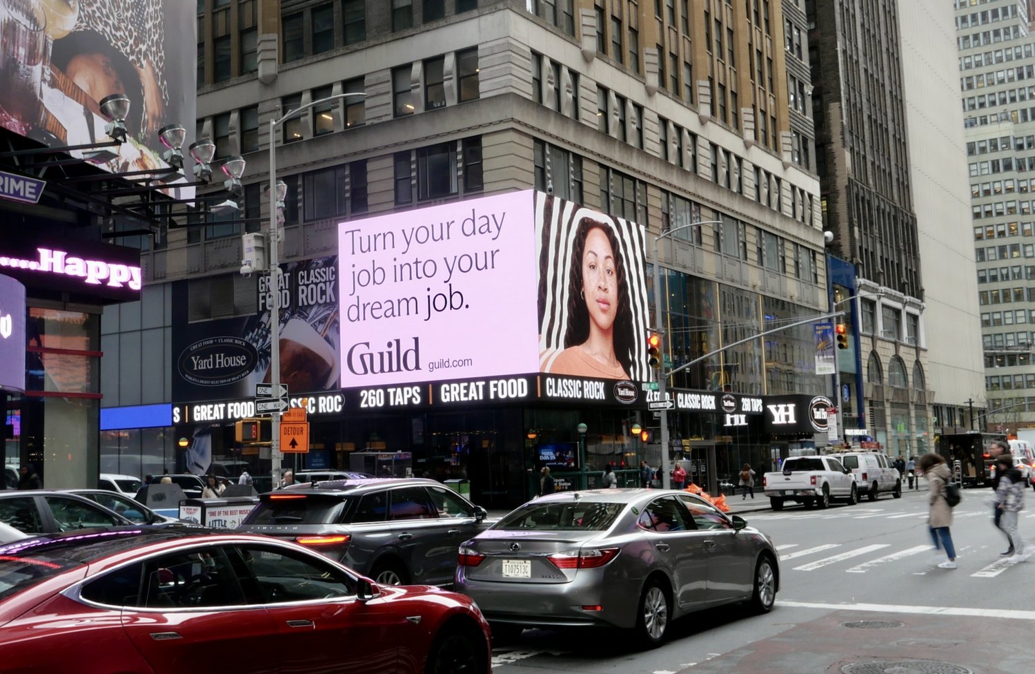Digital billboard in Times Square reading Turn your day job into your dream job.