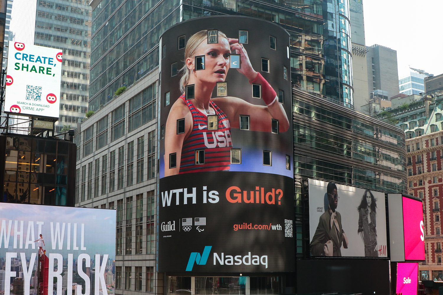 Guild's WTH is Guild? creative on the Nasdaq tower in Times Square, featuring a Team USA athlete.